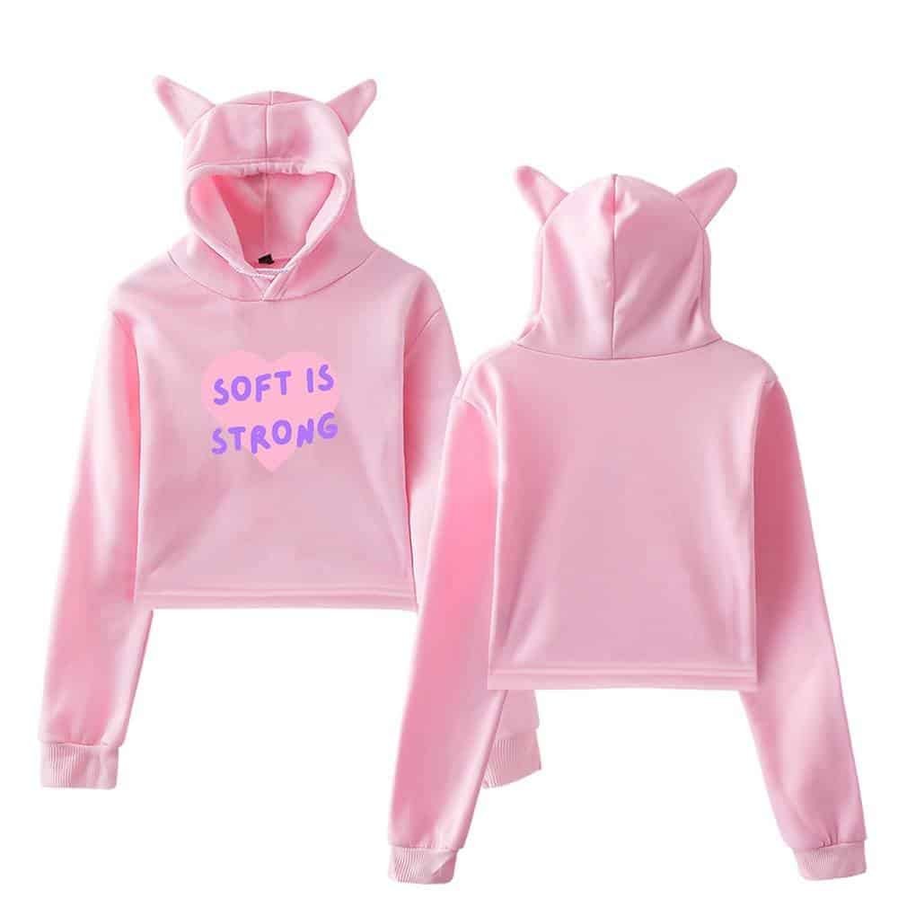 Pink hoodie and sweatpants set with cute cat ears on the hood, featuring the slogan "SOFT IS STRONG" in purple letters, made from affordable, high-quality materials, perfect for comfortable, stylish casual wear.