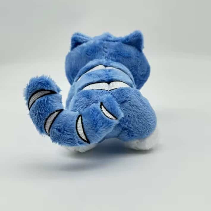 Super soft blue plush toy resembling a cartoon character with expressive embroidered features, perfect for affordable high-quality merchandise.