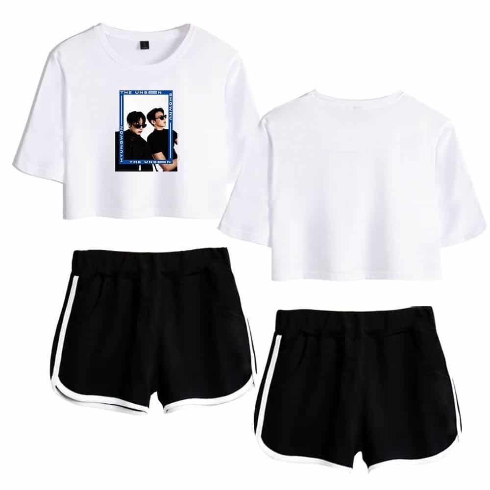 White cropped t-shirt with graphic print of two people wearing sunglasses and black athletic shorts with white stripe details.