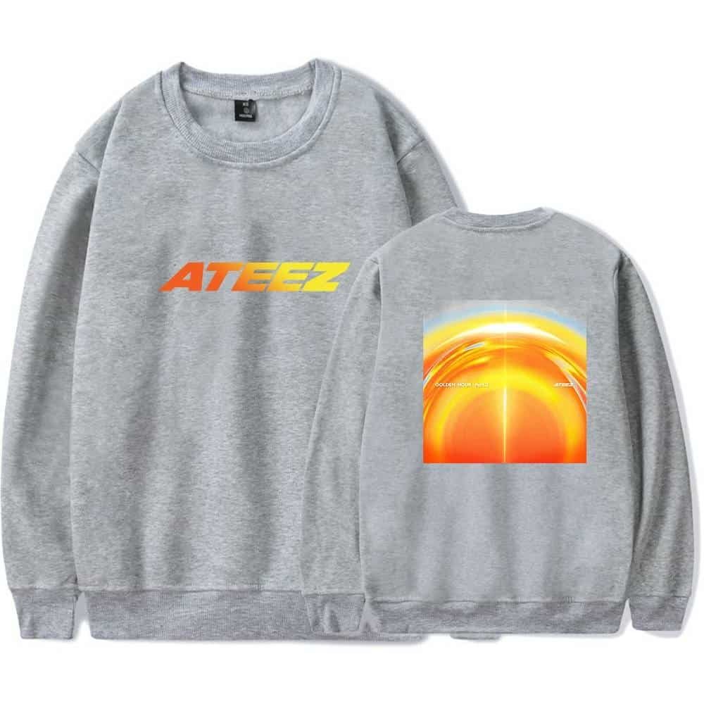 Simple grey sweatshirt featuring bold "ATEEZ" logo in orange and yellow, with a vibrant sunset graphic on the back, designed for affordable yet high-quality merchandise.