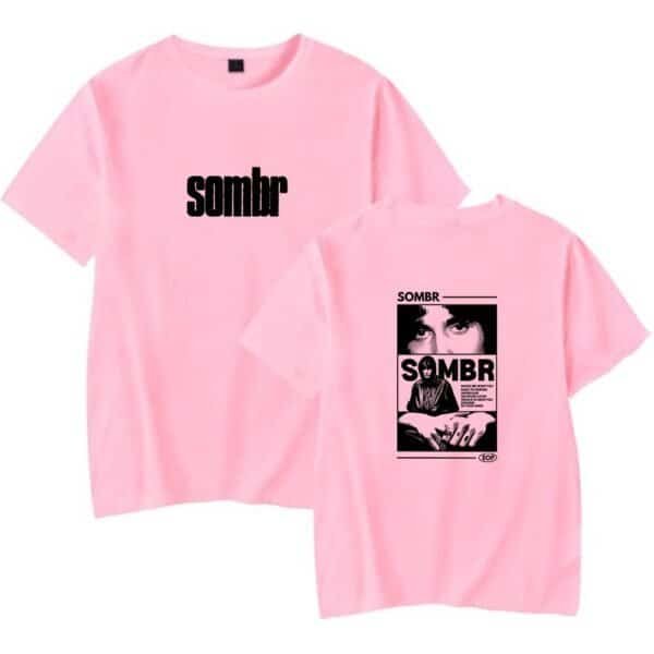 Sombr pink graphic t-shirt with black print, affordable high-quality casual wear for street style, slogan and artistic designs, unisex fit, comfortable cotton fabric suitable for everyday use.