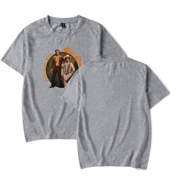 Grey t-shirt with a vintage style graphic print of two fashionable people, casual clothing, and retro design elements.