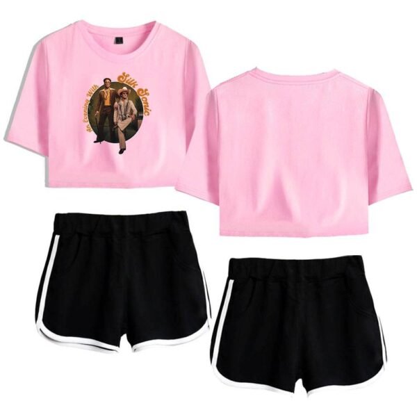 Pink casual cropped t-shirt with graphic print and black athletic shorts with white trim for women.