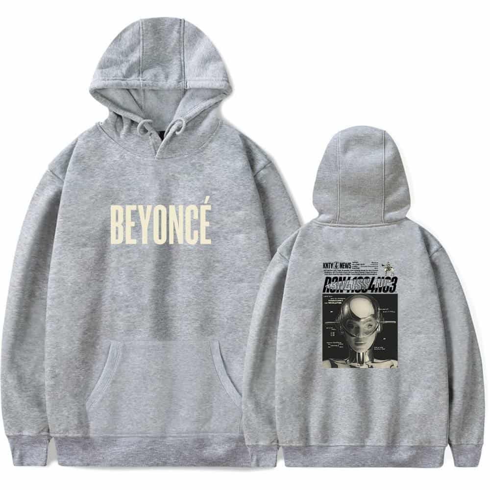 Comfy gray hoodie featuring a bold "BEYONCÉ" print on the front and a stylish graphic print of a woman with a helmet on the back, perfect for casual wear.
