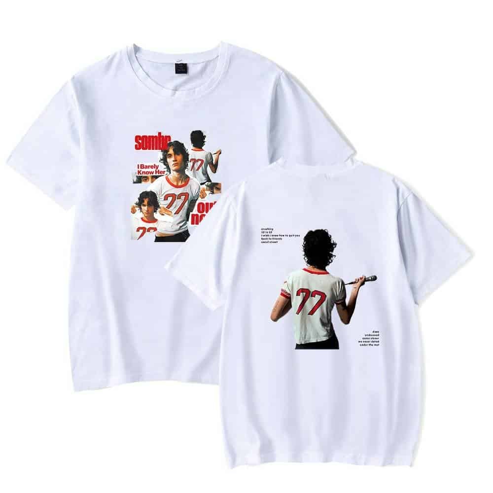 White graphic t-shirt featuring vintage-inspired design with bold text and images of a woman with curly hair holding a microphone, perfect for casual stylish wear.