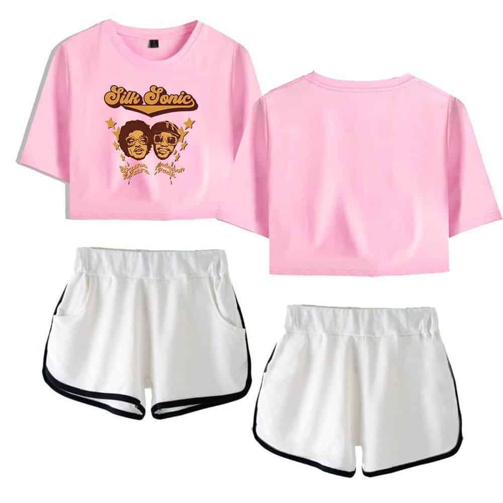 Pink "Silik Sonic" graphic crop top t-shirt with cartoon portraits and yellow accents, paired with white athletic shorts with black trim. Affordable, high-quality merchandise for casual and sporty style.