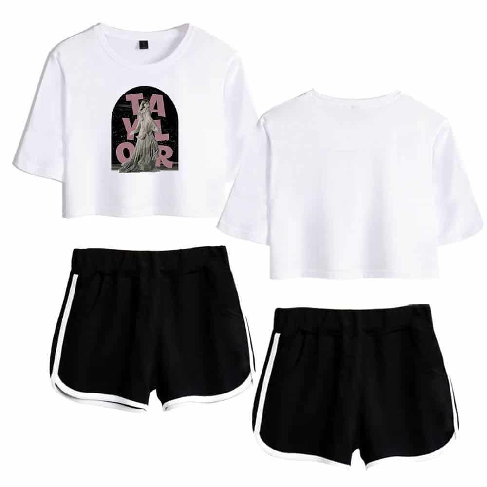White cropped graphic T-shirt with artistic design, paired with black athletic shorts with white side stripes, offering affordable, high-quality casual merch options for everyday wear.