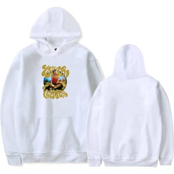Vibrant white hoodie with a colorful graphic design featuring a woman sitting outdoors, surrounded by nature, with bold yellow text above and below. High-quality, affordable, and stylish merch option.
